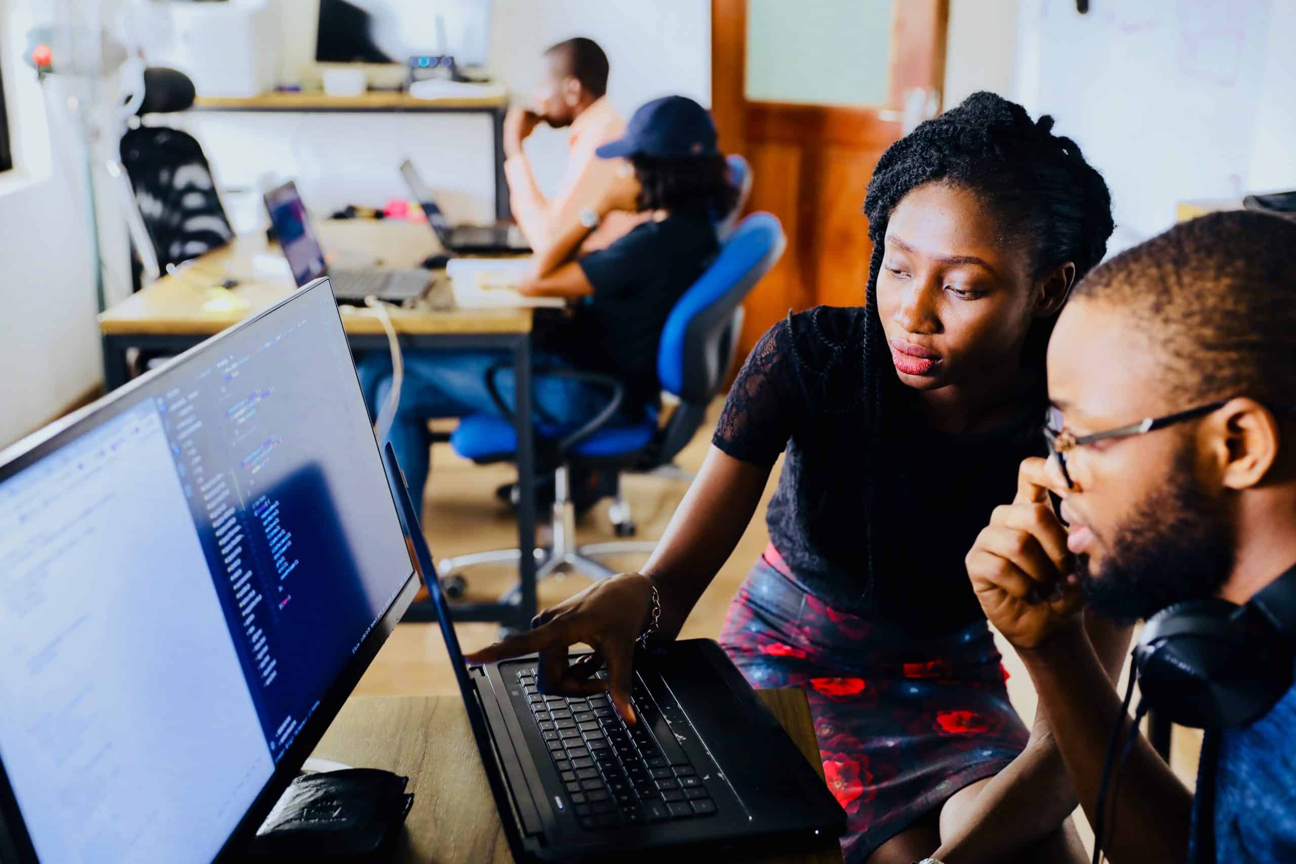 Businessman and Women Working on Laptop